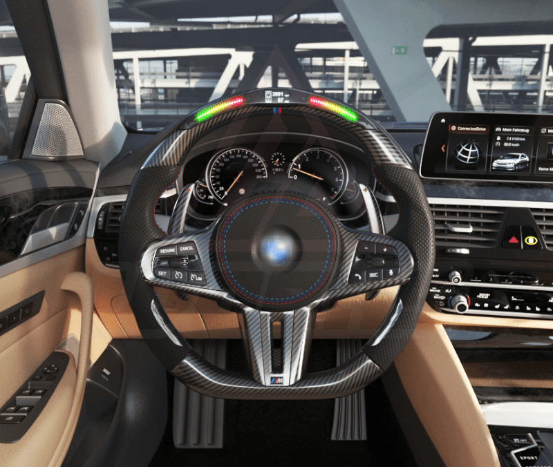 Front view of a BMW G/F chassis, M sport steering wheel in carbon fiber, black perforated leather, driving assistant buttons, m color accents and led shift lights